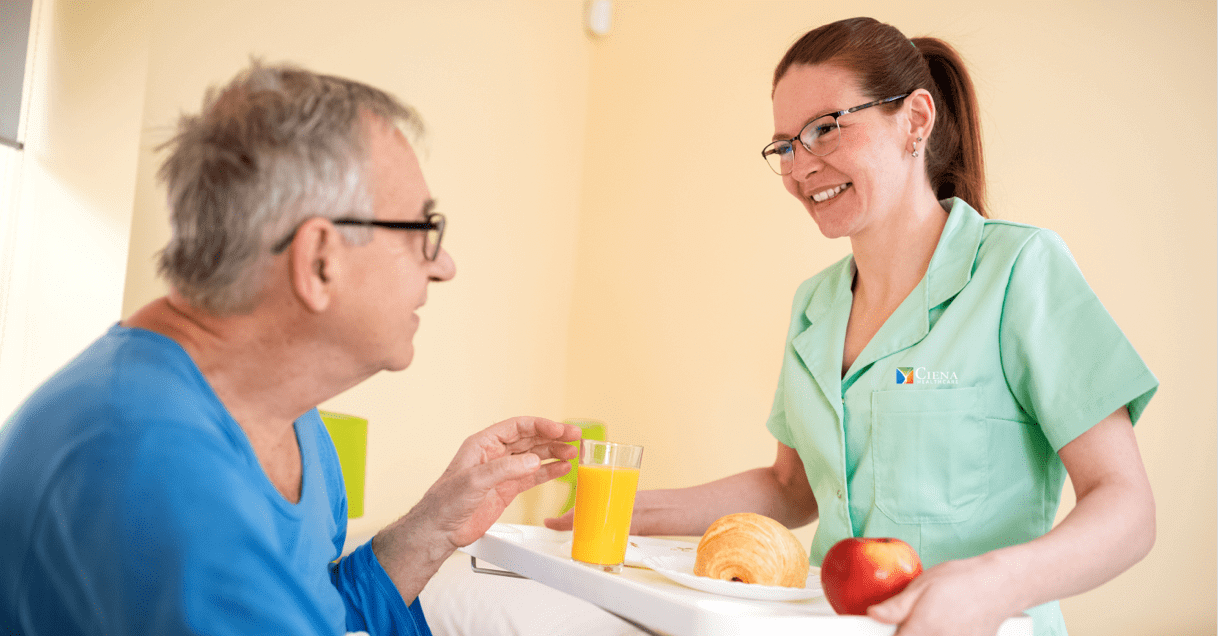 Ciena employee bringing a resident a tray of food