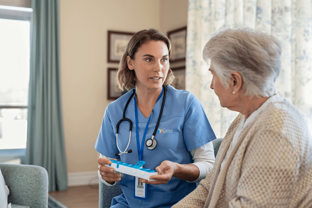 Ciena Employee assisting elderly woman with medication