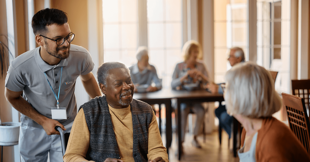 Ciena employee talking to residents at a dining table.