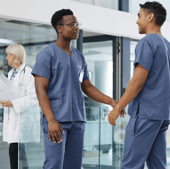 Healthcare professionals talking in a hospital hallway