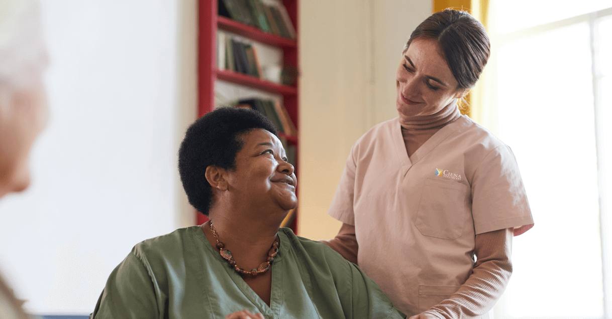 Nurse smiling at older woman