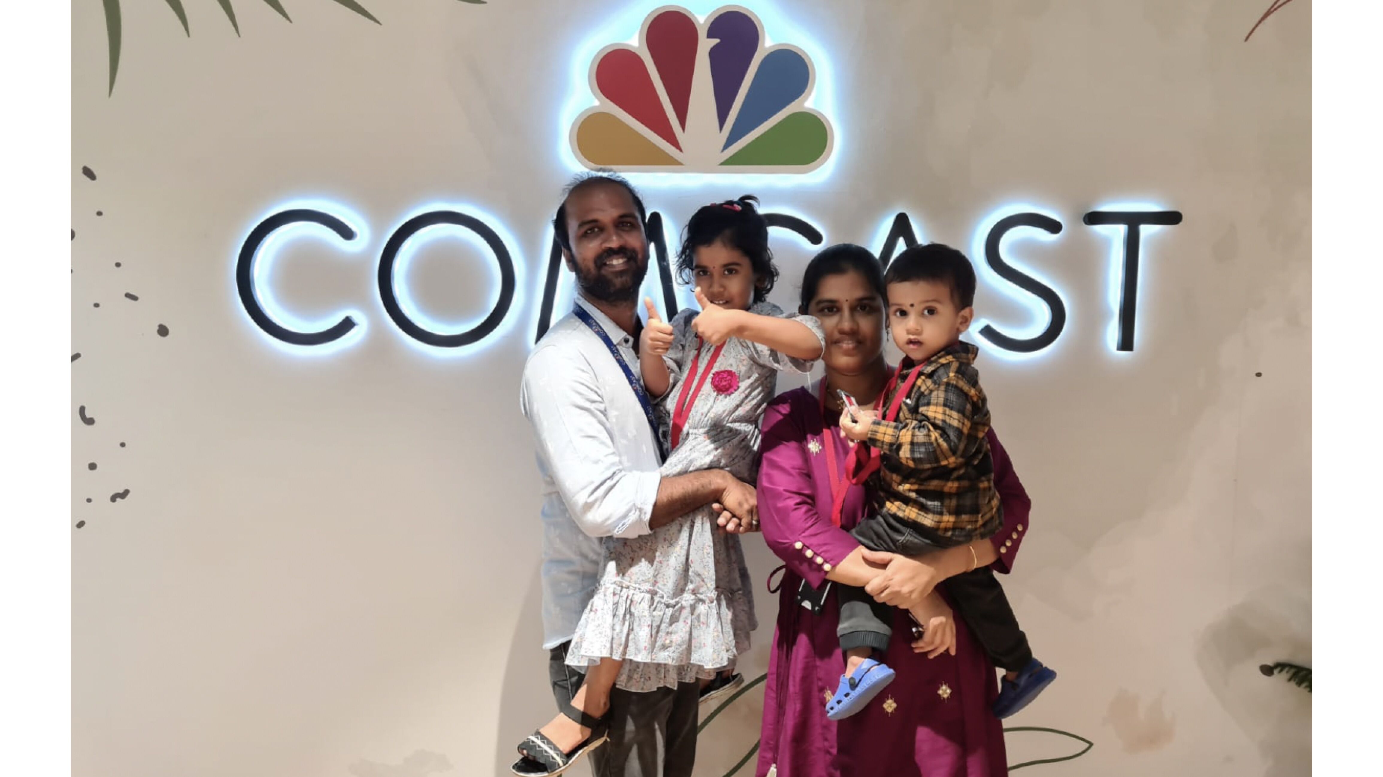 family in front of Comcast sign