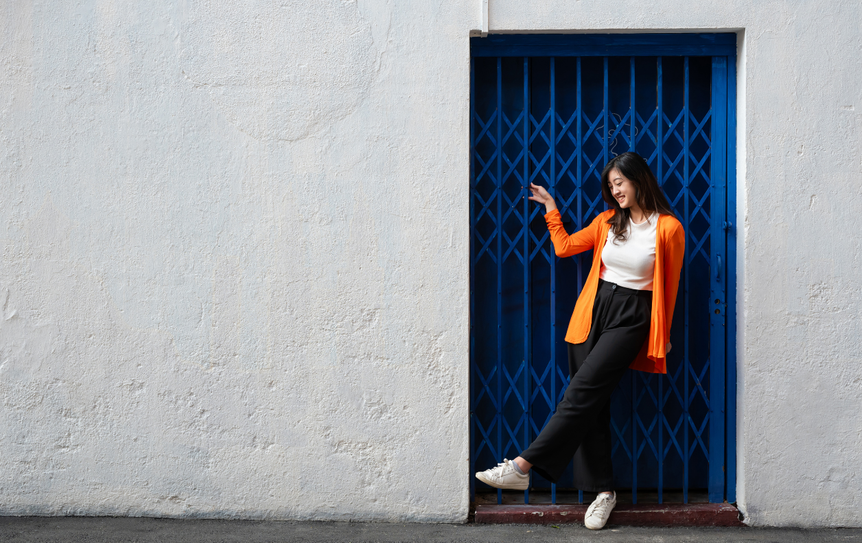 Woman posing by blue door