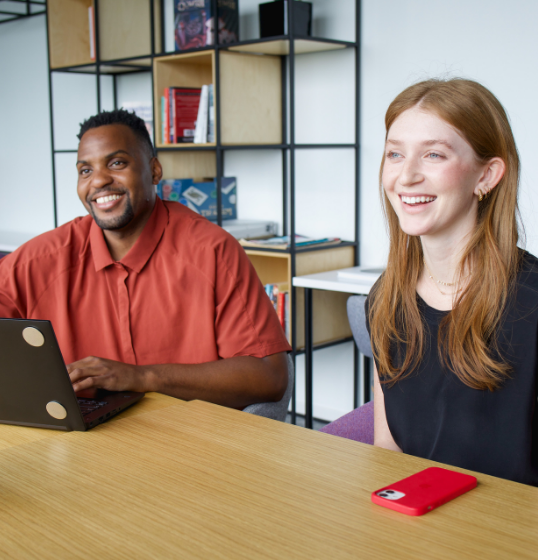 Employees smiling at conference table