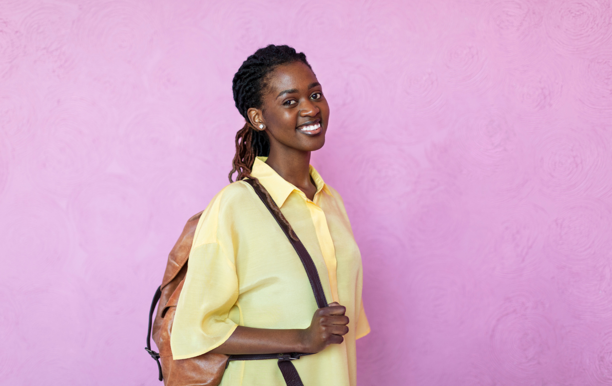 Student in front of pink wall