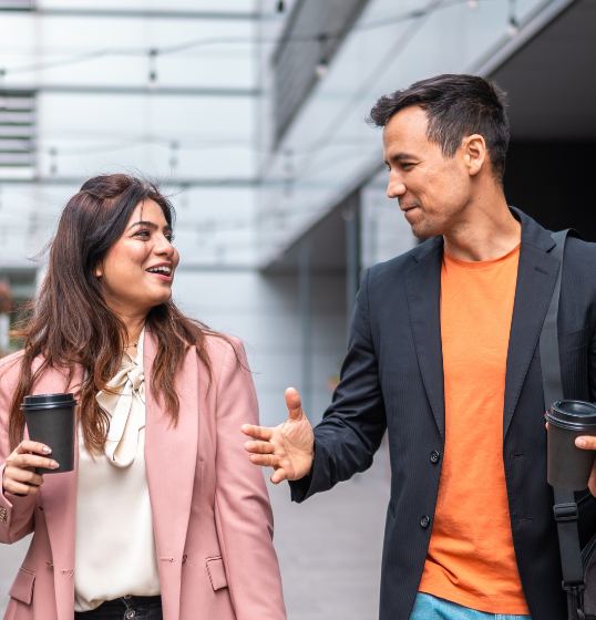 workers walking with coffee cups in hand