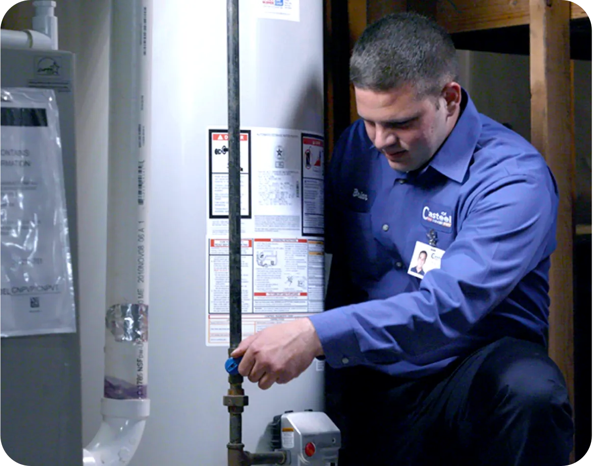 Technician installing a gas hot water heater.