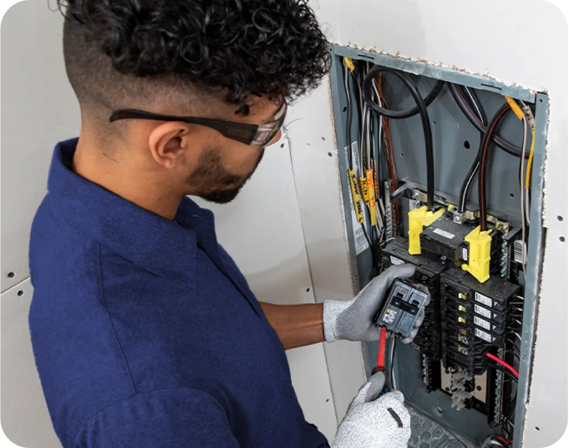 Technician working on an electrical panel.