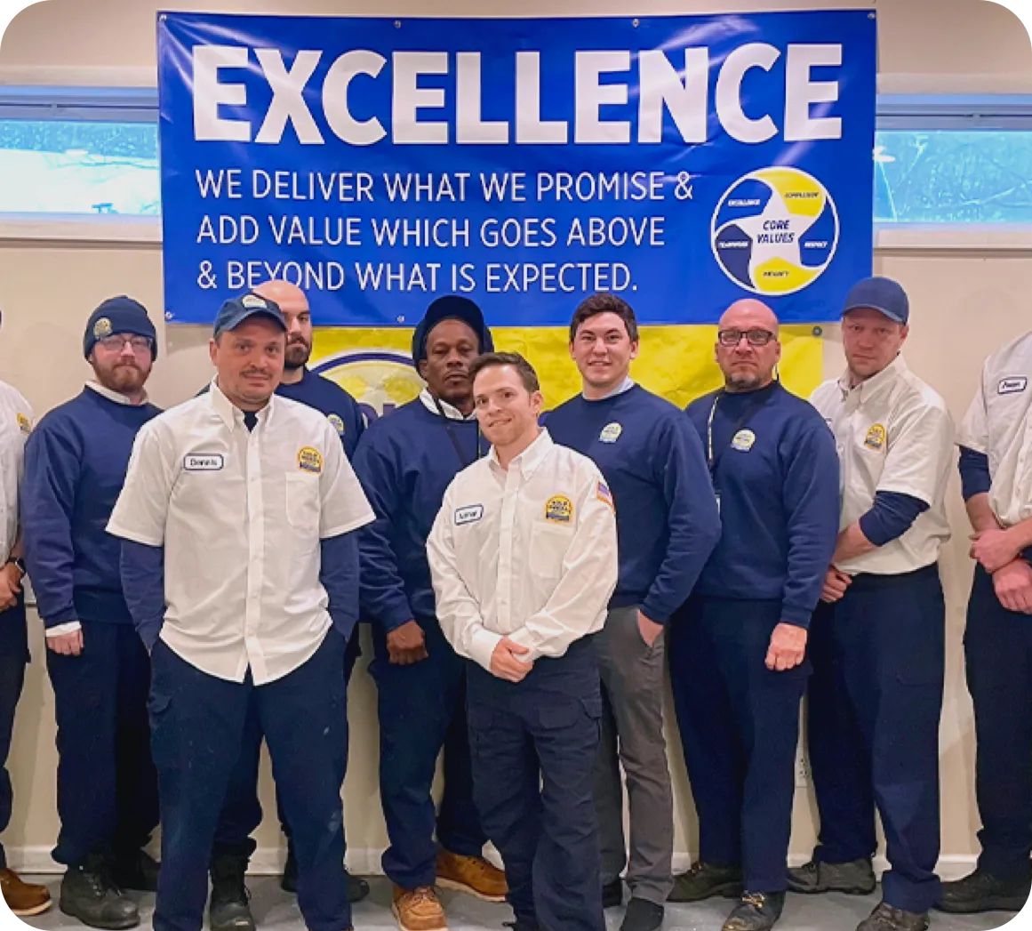 Employees smiling for the camera holding a trophy belt