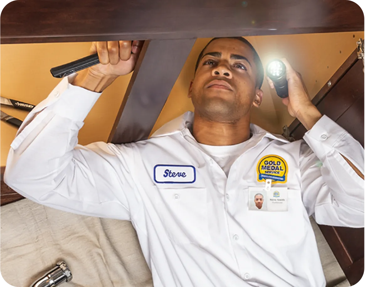 Technician installing a gas hot water heater.