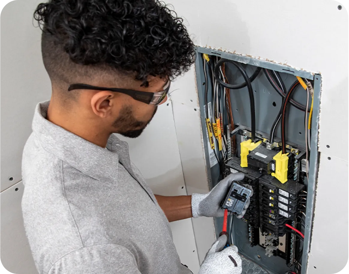 Technician working on an electrical panel.