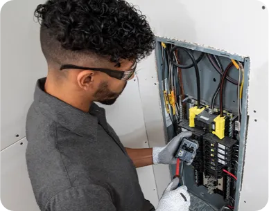 Technician working on an electrical panel.