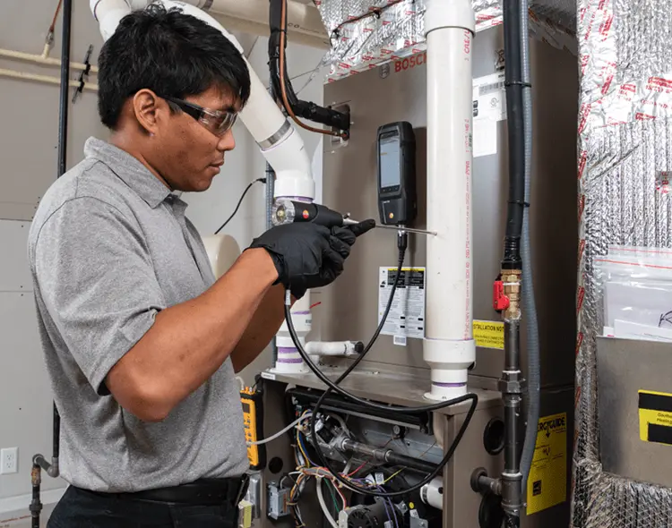 Technician working on an HVAC unit.