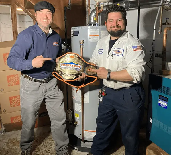 Employees smiling for the camera holding a trophy belt