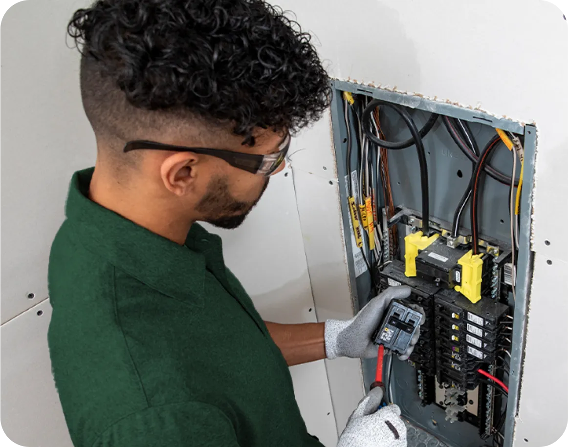 Technician working on an electrical panel.