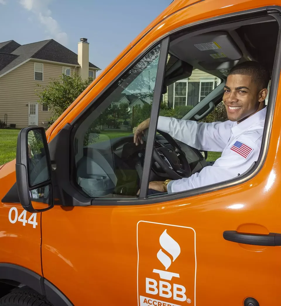 Employee smiling for the camera while sitting in a Horizon Services van