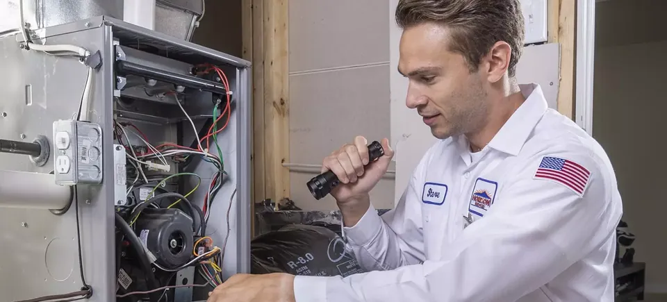 Technician looking at an HVAC system