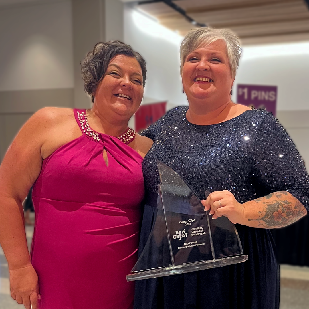 Two happy general managers holding an award for great performance