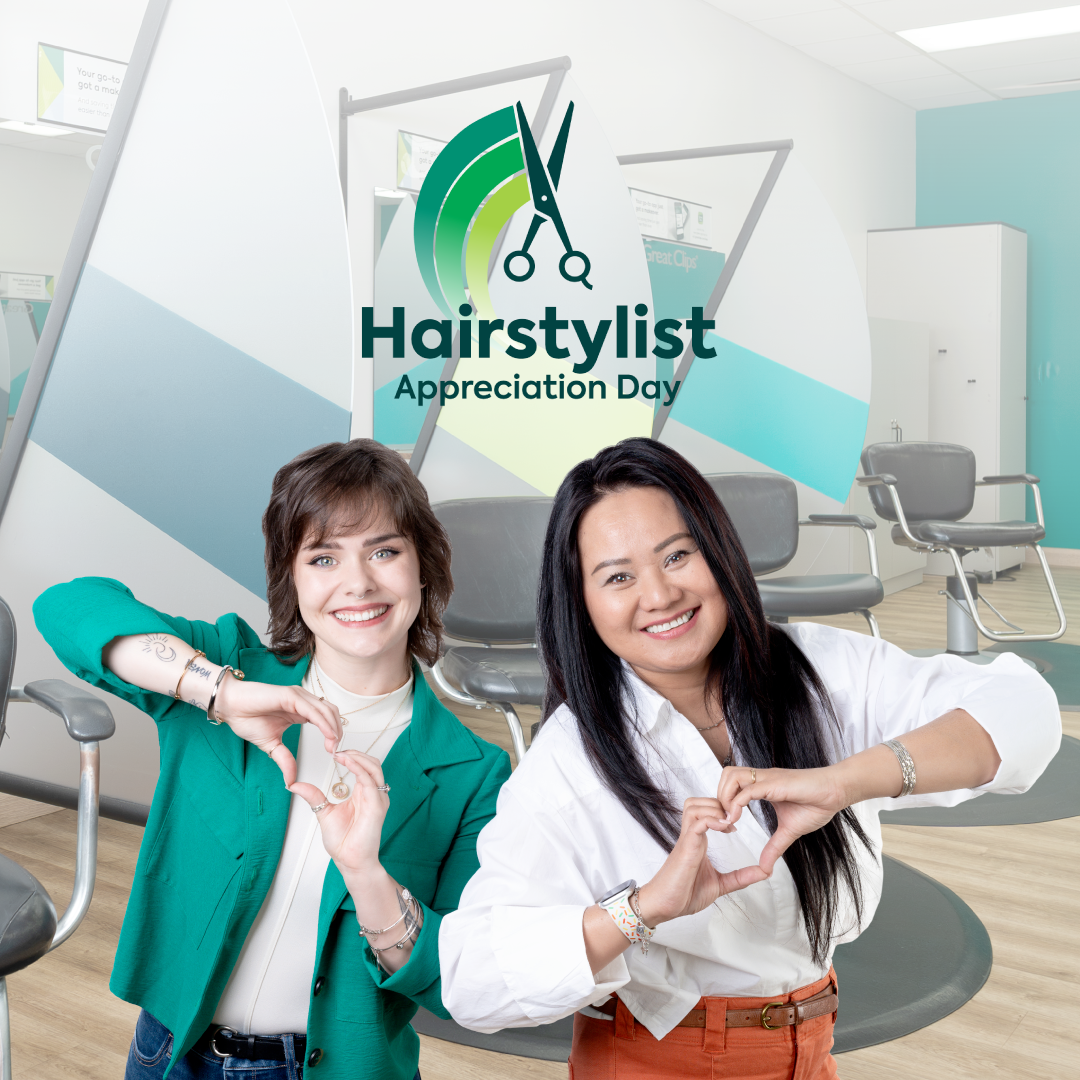 Two smiling stylists making heart shapes with their hands inside a Great Clips salon. A Hairstylist Appreciation Day logo floats above them.