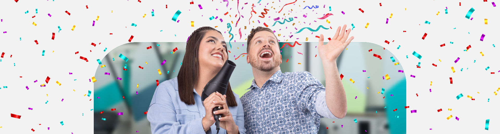 Two smiling stylists with a blow dryer, confetti everywhere