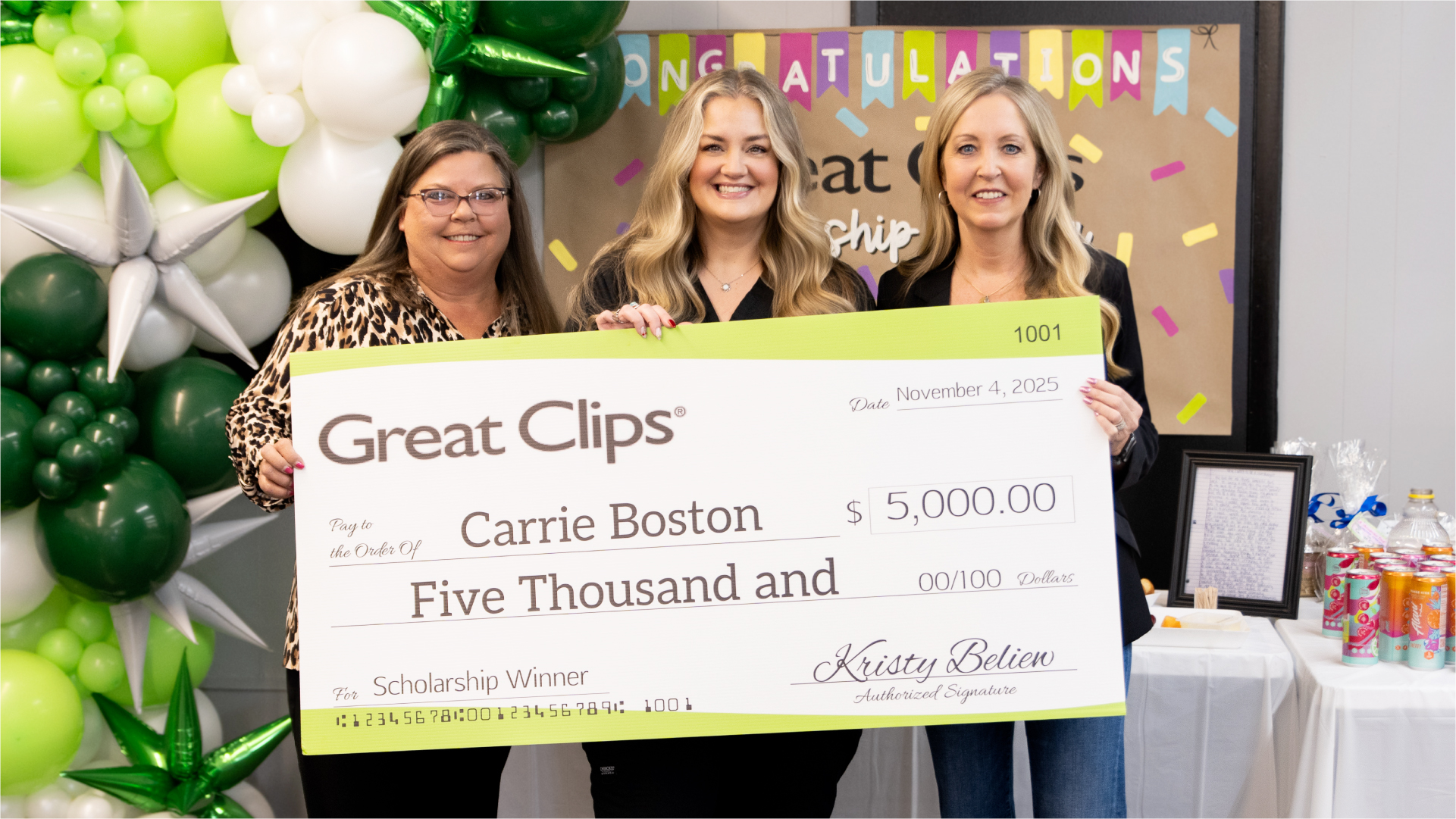 Scholarship recipient and franchisee smiling with giant scholarship check