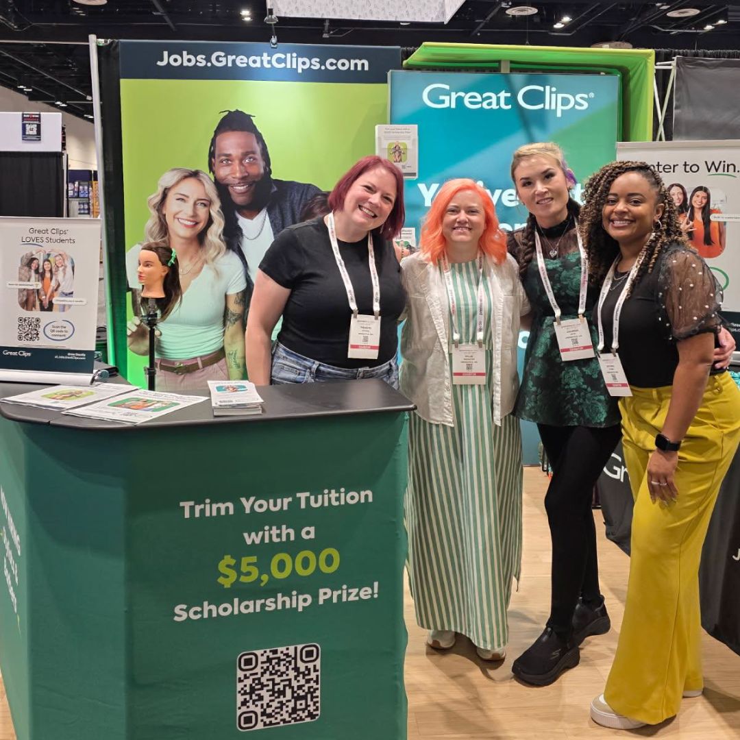Smiling group of women standing in Great Clips booth at Premiere Orlando hair show