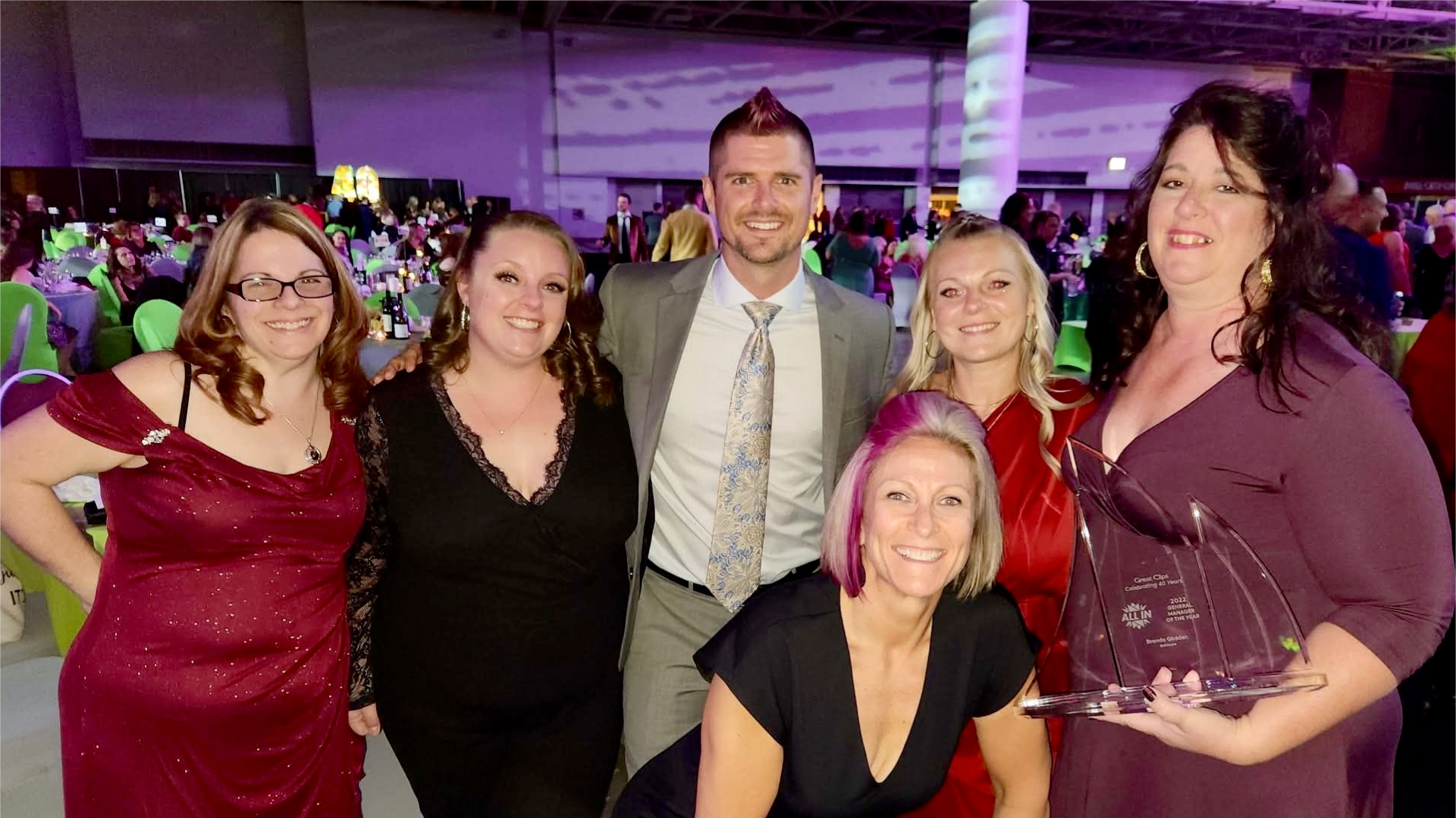 Brenda celebrates with Monster Truck driver Bryce Kenny and colleagues after her GM of the Year win