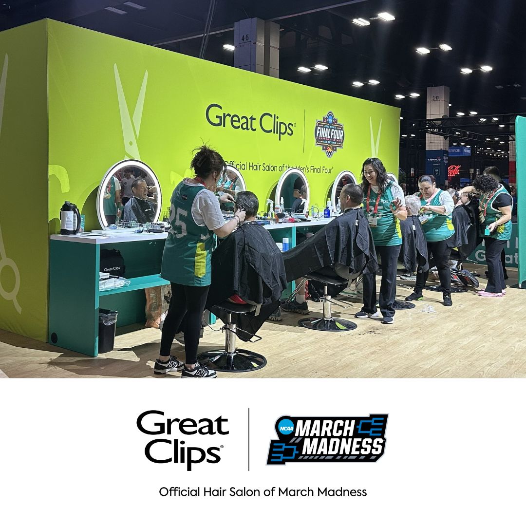 Great Clips stylists cut hair at the March Madness Fan Fest. A white footer contains the logos for Great Clips and March Madness, with the caption: Official Hair Salon of March Madness.