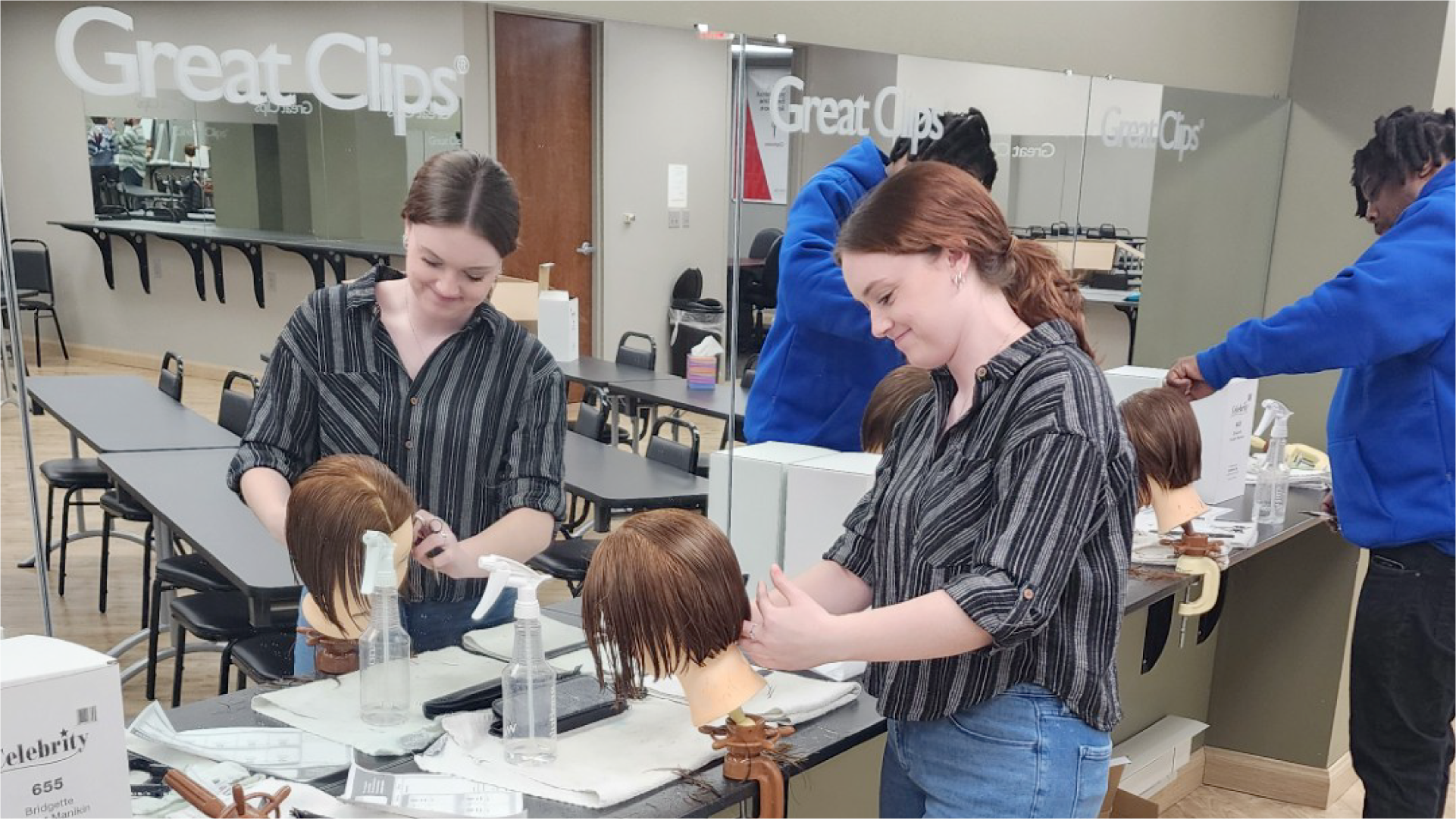 New stylists practicing on mannequins in a training center