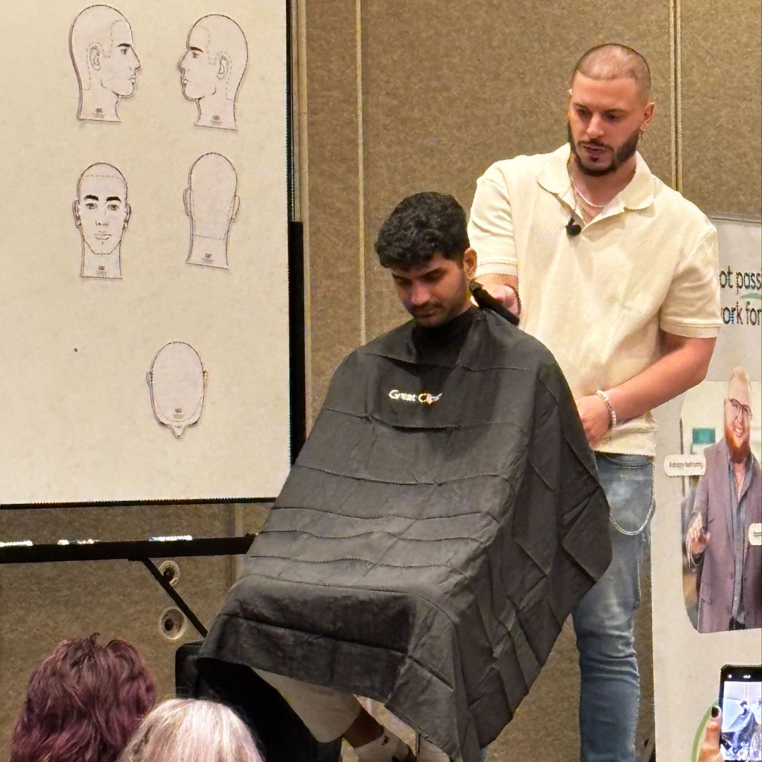 Barber educator cutting man's hair.