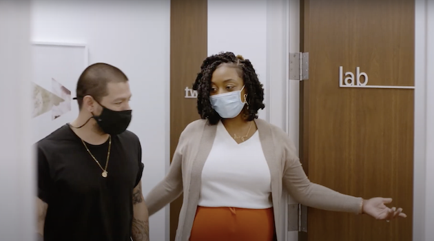 medical professional leading patient to a lab.