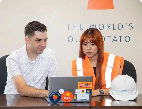 Two people looking at laptop screen