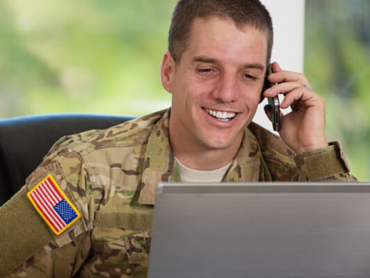 Military man looking at laptop