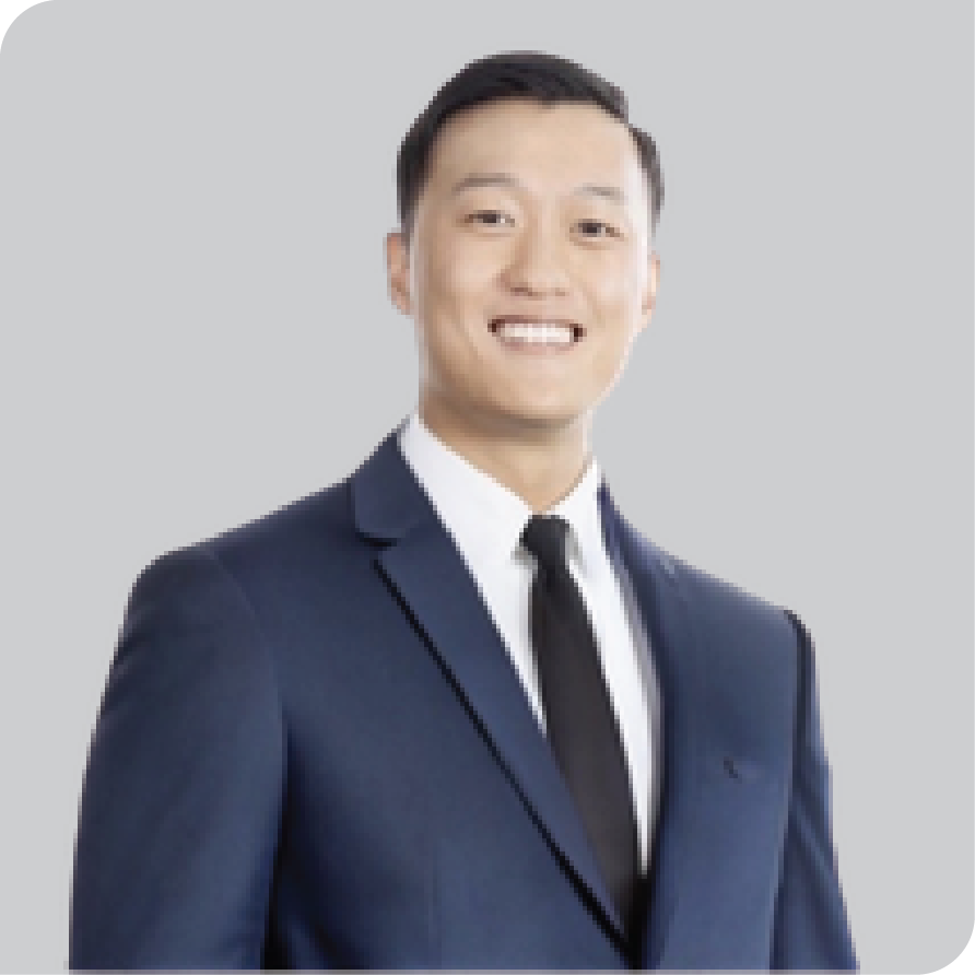 Asian man blue suit black tie white shirt smiling