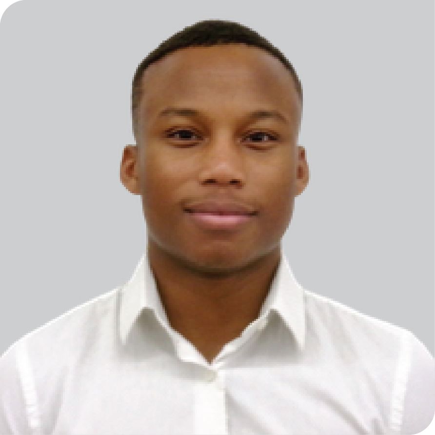 Black man in white oxford smiles at camera