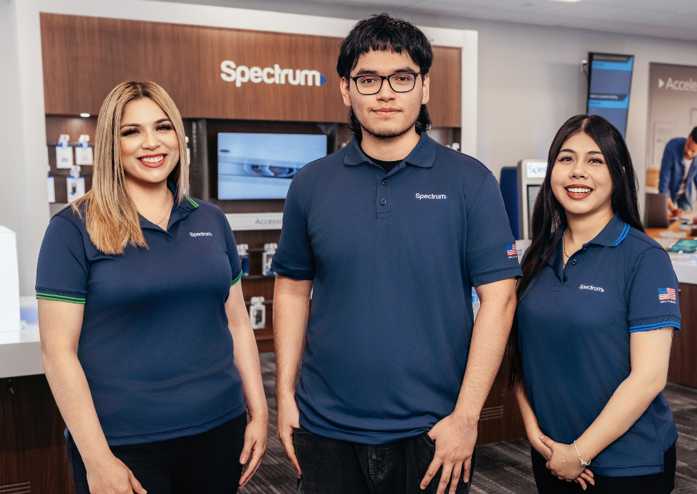 Spectrum employees standing together in a retail store