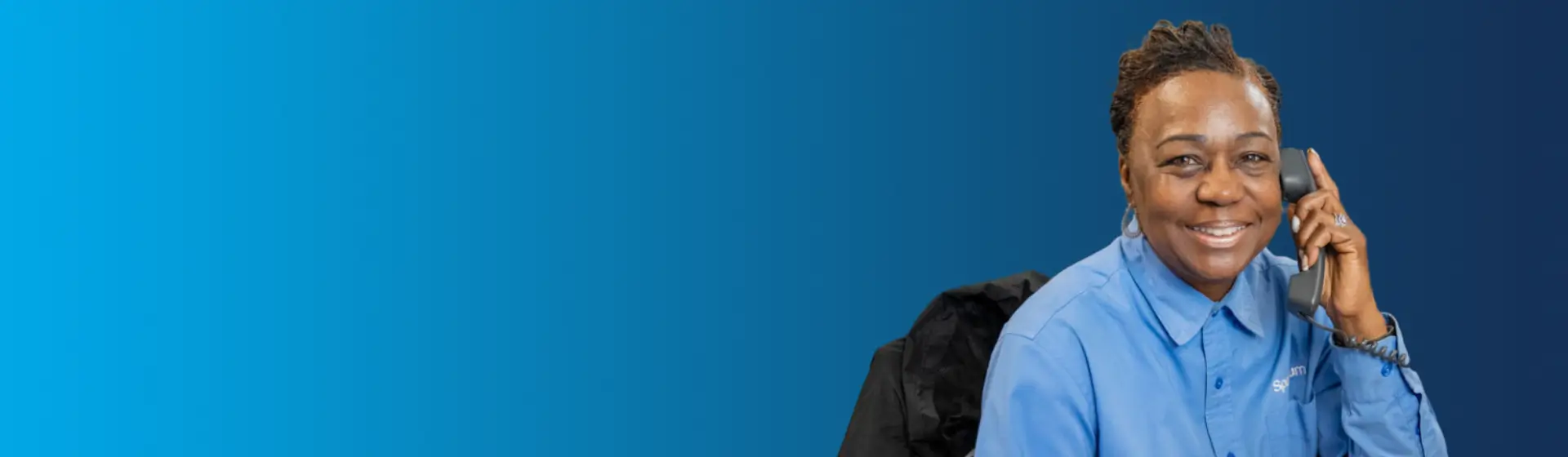 spectrum call center employee on the phone and smiling at camera