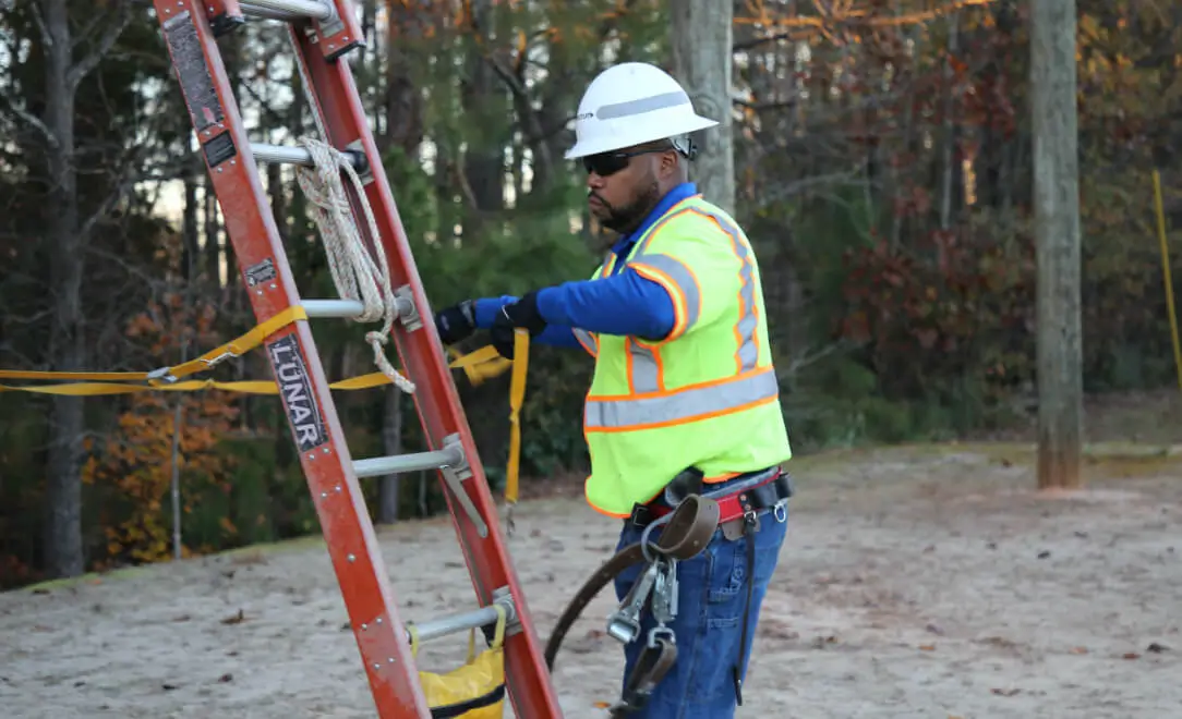spectrum field technician climbing a ladder