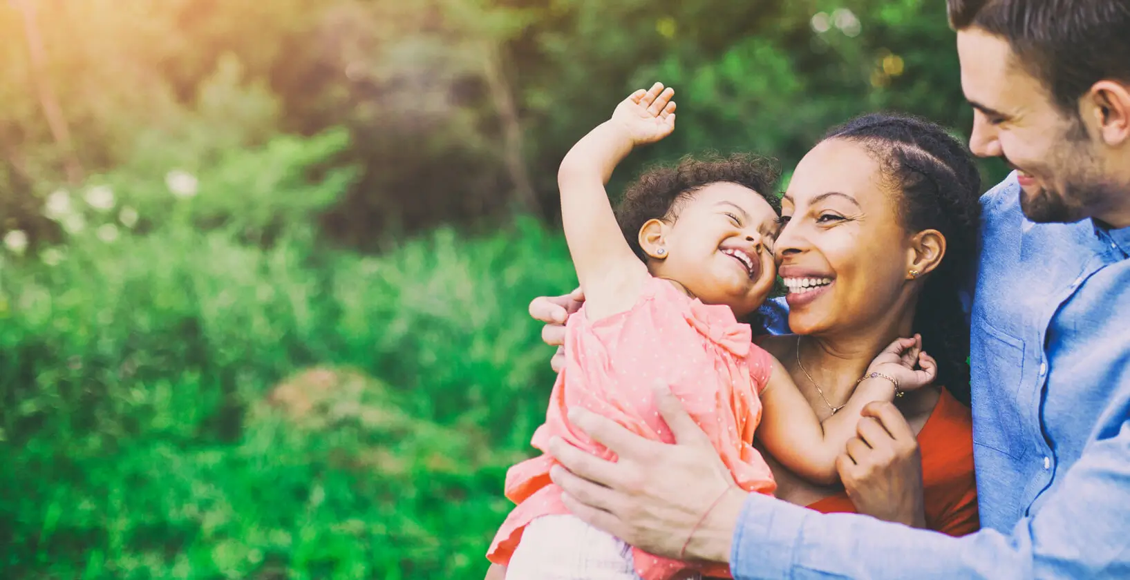 happy couple with a toddler in their arms