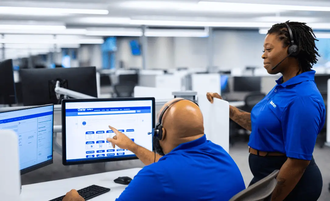 spectrum employees talking with headsets on a computer