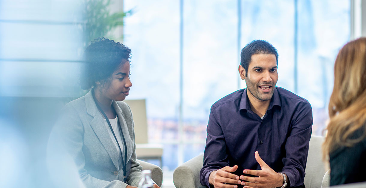 3 Spectrum employees in business attire having conversation