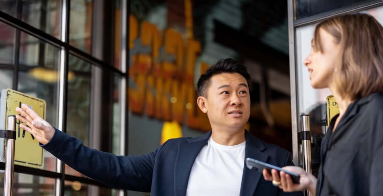 Two employees in business attire looking at a presentation