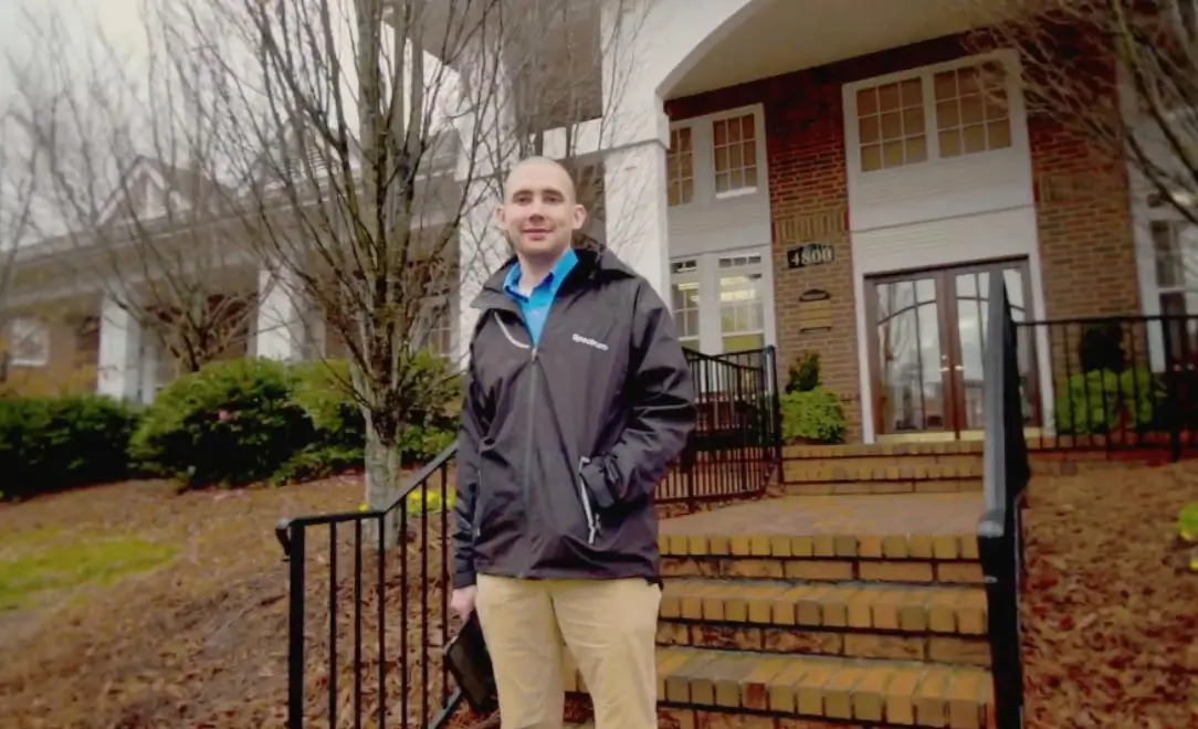 spectrum employee standing outside of a building ready to sell spectrum services and products