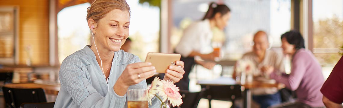 Smiling woman using phone