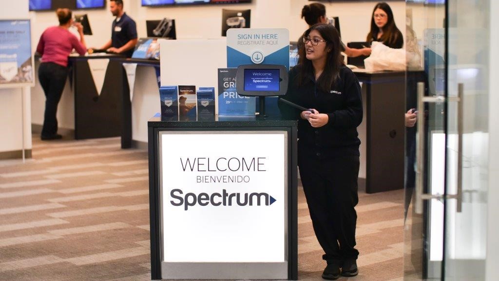 Girl standing next to Spectrum sign