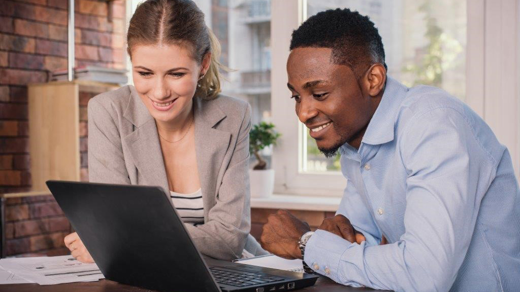 Two people looking at laptop