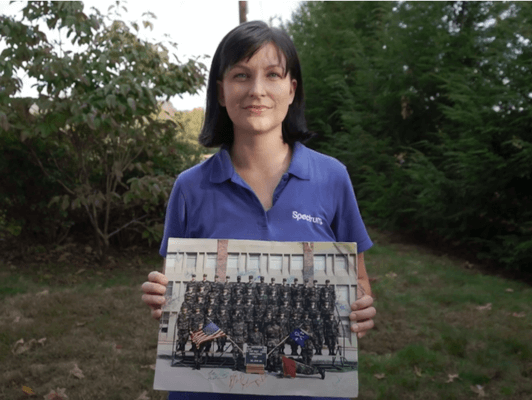 Woman holding military picture