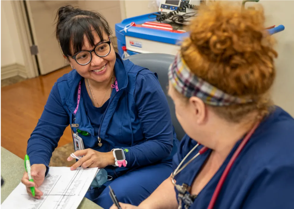 Two nurses reviewing continuing education options