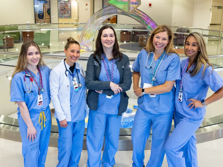 A group of nurses in a hospital lobby