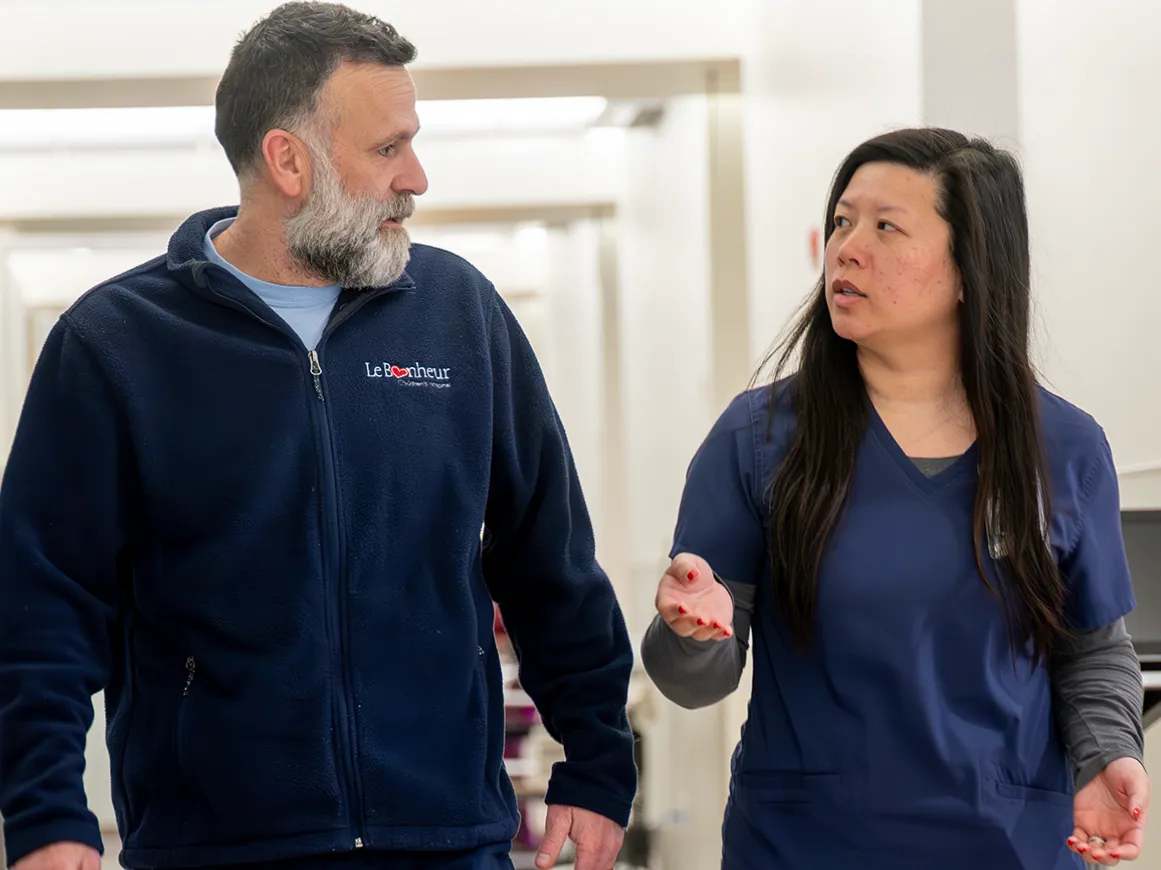 Two nursing support coworkers in a hallway